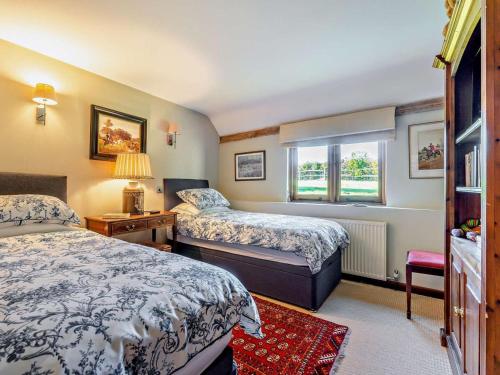 a bedroom with two beds and a window at 3 Bed in Heathfield oc-93718 in Dallington