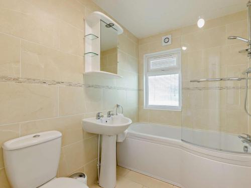 a bathroom with a toilet and a sink and a tub at 3 Bed in Okehampton oc-95636 in Okehampton