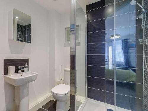 a bathroom with a toilet and a sink and a shower at 2 Bed in Y Felinheli oc-86260 in Y Felinheli