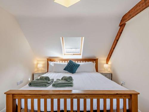 a bedroom with a bed with green towels on it at 4 Bed in Ilfracombe oc-43640 in Berrynarbor