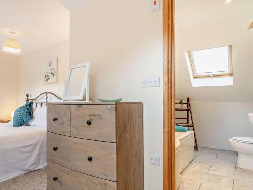 a bedroom with a dresser with a laptop on top of it at 4 Bed in Ilfracombe oc-43640 in Berrynarbor