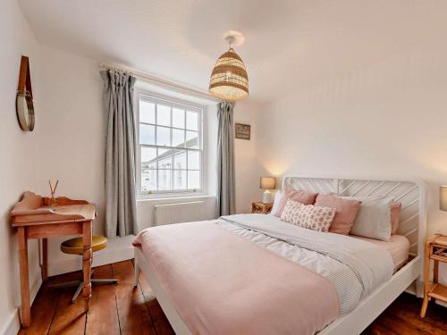 a bedroom with a bed and a desk and a window at 2 Bed in Bideford oc-52863 in Appledore