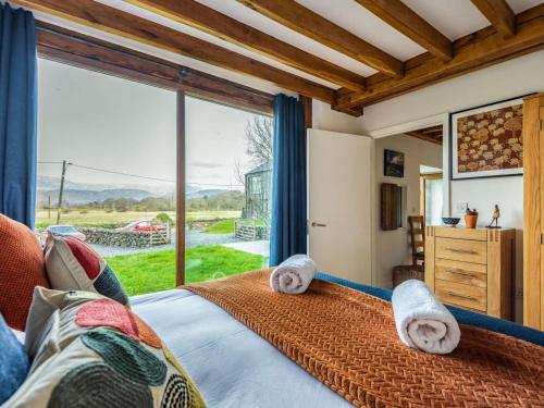 a bedroom with a bed and a large window at 2 Bed in Arthog oc-66611 in Arthog