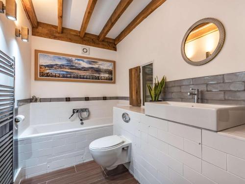 a bathroom with a sink and a toilet and a tub at 2 Bed in Arthog oc-66611 in Arthog