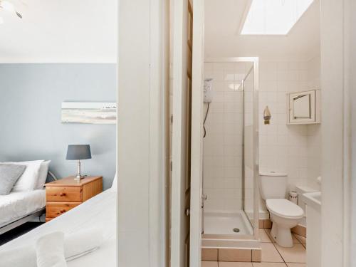 a bathroom with a bed a toilet and a bath tub at 2 Bed in Brixham oc-bx079 in Brixham