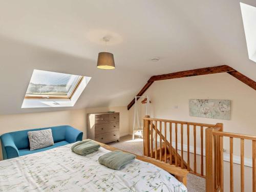 a bedroom with a bed with a blue chair at 1 Bed in Ilfracombe oc-43641 in Berrynarbor