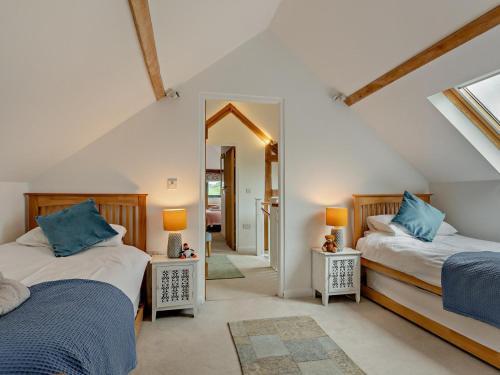 a bedroom with two beds and a mirror at 5 Bed in Dulverton oc-41133 in Brushford