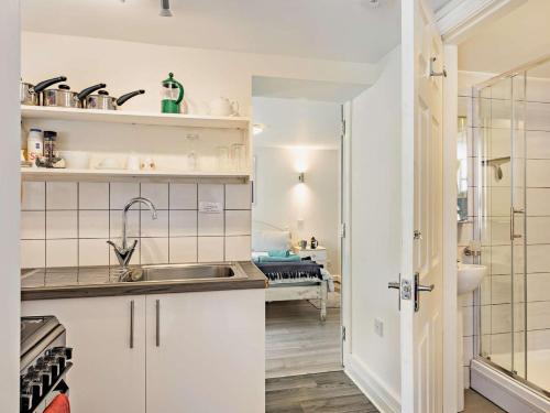 a small kitchen with a sink and a bathroom at 1 Bed in Llangollen oc-92336 in Llangollen