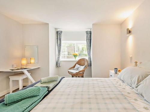 a bedroom with a bed and a desk and a window at 1 Bed in Llangollen oc-92336 in Llangollen