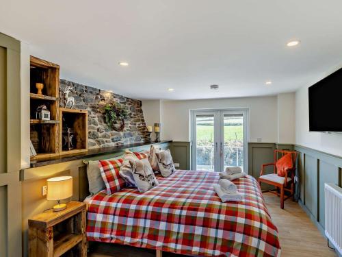 a bedroom with a large bed and a tv at 2 Bed in Llanidloes oc-95815 in Llanidloes