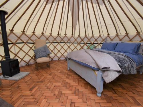 a bedroom in a yurt with a bed and a stove at 1 Bed in Llandysul oc-85415 in Rhyd Owen