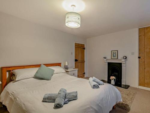 a bedroom with a large bed with towels on it at 2 Bed in South Molton oc-55221 in Bishops Nympton