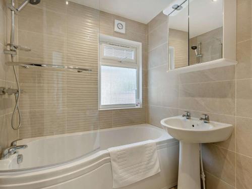 a white bathroom with a sink and a tub and a sink at 2 Bed in Okehampton oc-85432 in Okehampton