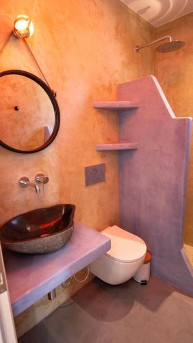 a bathroom with a sink and a toilet and a mirror at Casa Elezi in Koufonisia
