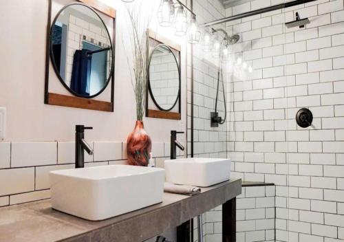 a bathroom with two sinks and two mirrors at Rivers Edge Lofts - Unit 2 in Niles