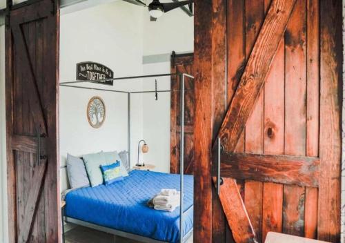 a bedroom with a blue bed and a wooden wall at Rivers Edge Lofts - Unit 2 in Niles