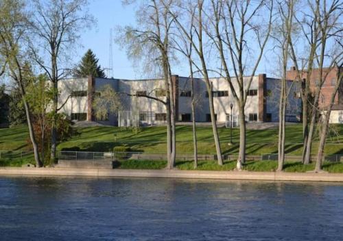 a building next to a body of water at Rivers Edge Lofts - Unit 2 in Niles