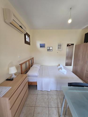 a hotel room with two beds and a sink at Sea Nest Studio 1 in Agia Ermioni