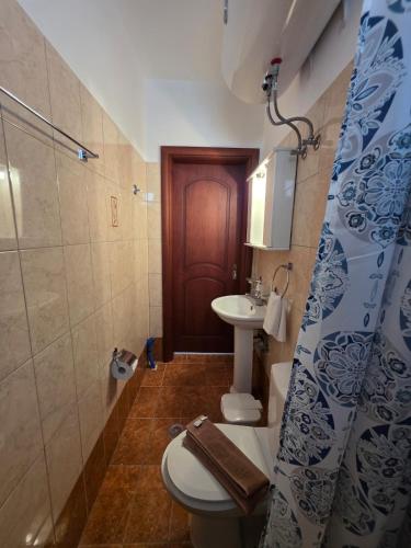 a bathroom with a toilet and a sink at Sea Nest Studio 1 in Agia Ermioni