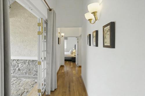 a hallway with a door leading to a bedroom at Aadya Tea Bungalows by Aahaasa in Hatton