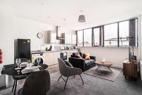 a living room with a couch and a table at Smart 1 Bed Apartment in Central Wrexham in Wrexham