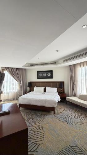 a large hotel room with a bed and a couch at Noon Hotel Suites in Khafji