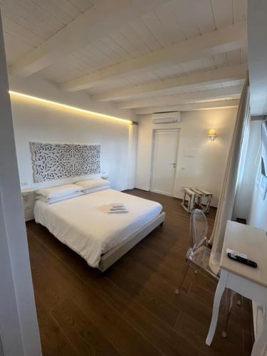 a bedroom with a large white bed in a room at Olbia City Hotel & Spa in Olbia