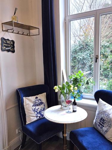 a table and two chairs and a table and a window at Midcoast Studio TheBlue in Nortorf