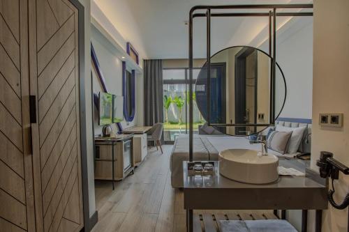 a bathroom with a sink and a large mirror at Armella Hill Hotel in Side