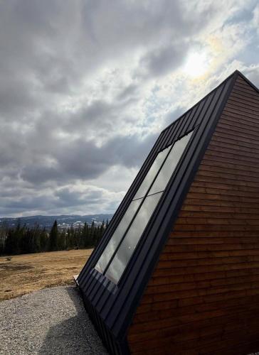 a house with a large window on the side of it at Yatak in Vatra Dornei