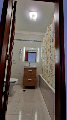 a bathroom with a sink toilet and a mirror at Serenity Villa in Porches