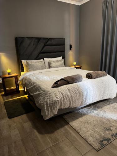 a bedroom with a large bed with white sheets and pillows at Immari stays in Swakopmund