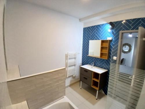a bathroom with a sink and a mirror at Hôtel Quai d'Azur in Le Grau-du-Roi