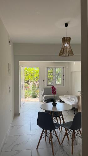 a kitchen and dining room with a table and chairs at Ella apartments in Parga