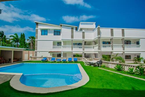 a house with a swimming pool in front of it at Diani Dream stays 2 in Diani Beach