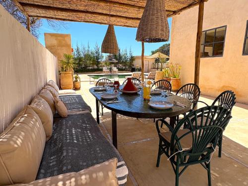 a patio with a couch and a table and chairs at Palais Zoa in Essaouira