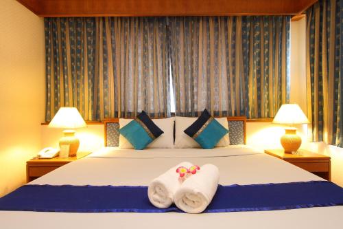 Ένα ή περισσότερα κρεβάτια σε δωμάτιο στο Silom Avenue Inn