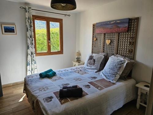a bedroom with a large bed and a window at le balcon du Canigo' in Escaro