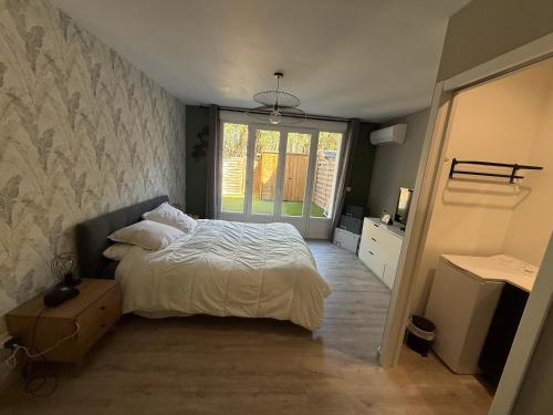 a bedroom with a white bed and a window at maison 6 personnes villa sofia in Sainte-Maxime
