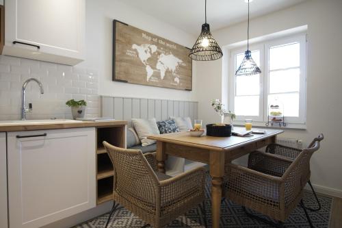 a kitchen with a table and chairs in a kitchen at Ferienwohnung Zweites Zuhause in Büsum