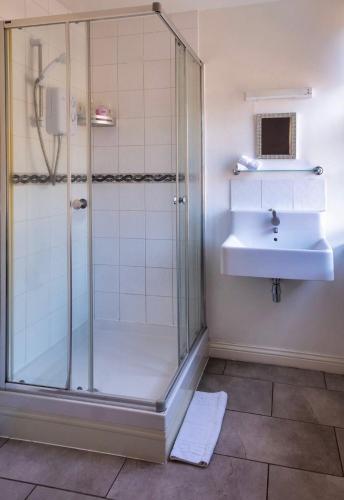 a bathroom with a shower and a sink at The Three Coopers in Bedale