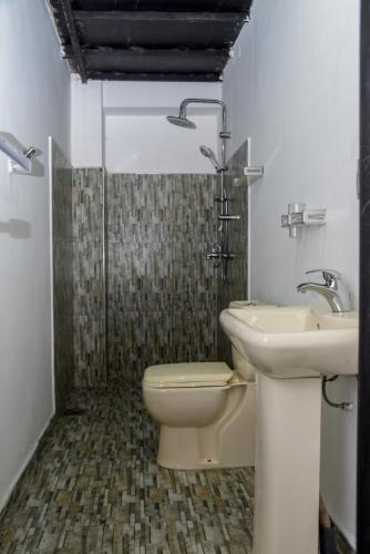 a bathroom with a toilet and a sink at Shiny cot resort in Nuwara Eliya