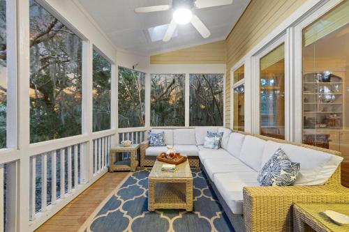 a screened in porch with a couch and a table at MH3012: 3012 Marsh Haven in Seabrook Island