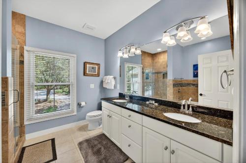 a bathroom with a sink and a toilet and a mirror at SM04: 4 Silver Moss in Kiawah Island