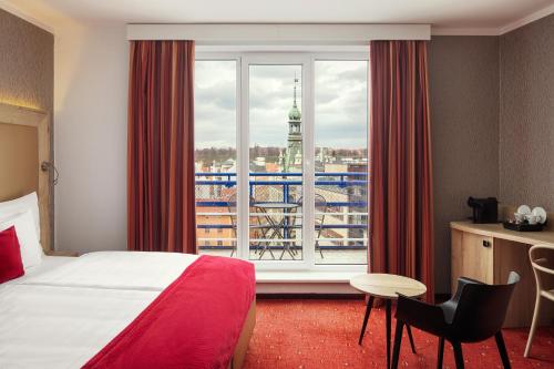 a hotel room with a bed and a large window at Astoria Hotel in Prague