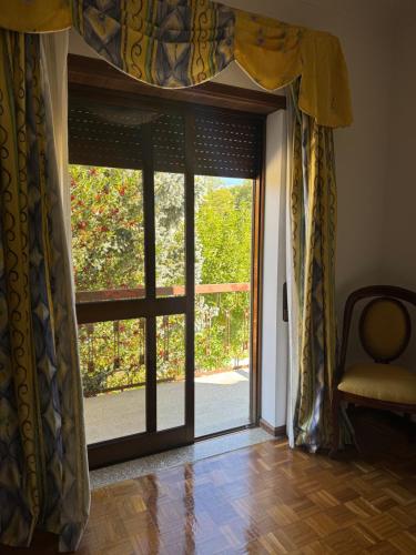 an open glass door with a view of a yard at Casa Vicente in Lamego