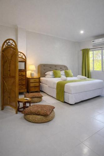 a large bedroom with two beds and a window at Heidi's Guesthouse in Siquijor