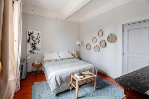 a white bedroom with a bed and a table at Contemporary bastide in Aix in Aix-en-Provence