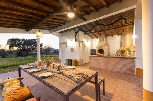 a patio with a table and an outdoor kitchen at Monte do Sossego by Portugal Active in Ferreira do Alentejo