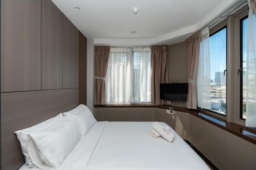 a hotel room with a bed and a window at Wangs Hotel Gurney Drive in George Town